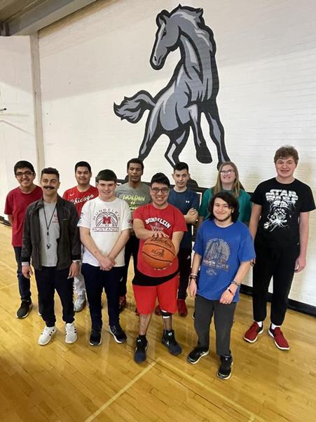 The MHS Special Olympics basketball team gathers for a team photo in the gymnasium.