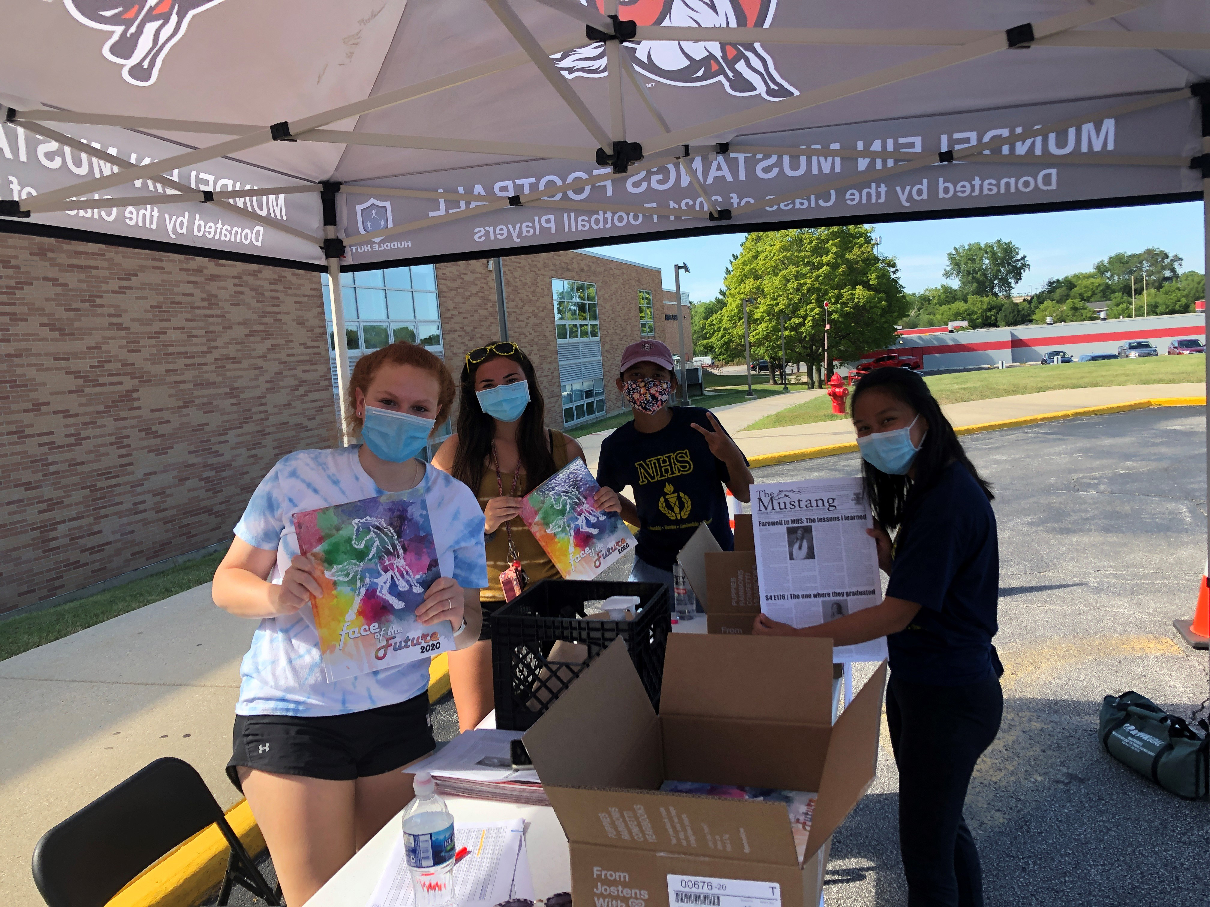 Yearbook staff members distributing yearbooks last summer