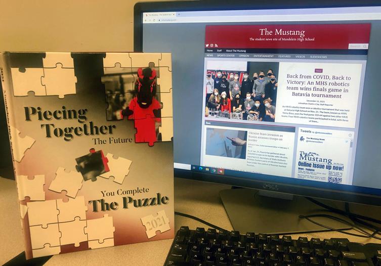 The printed version of the MHS yearbook stands next to a computer showing the school's digital newspaper.