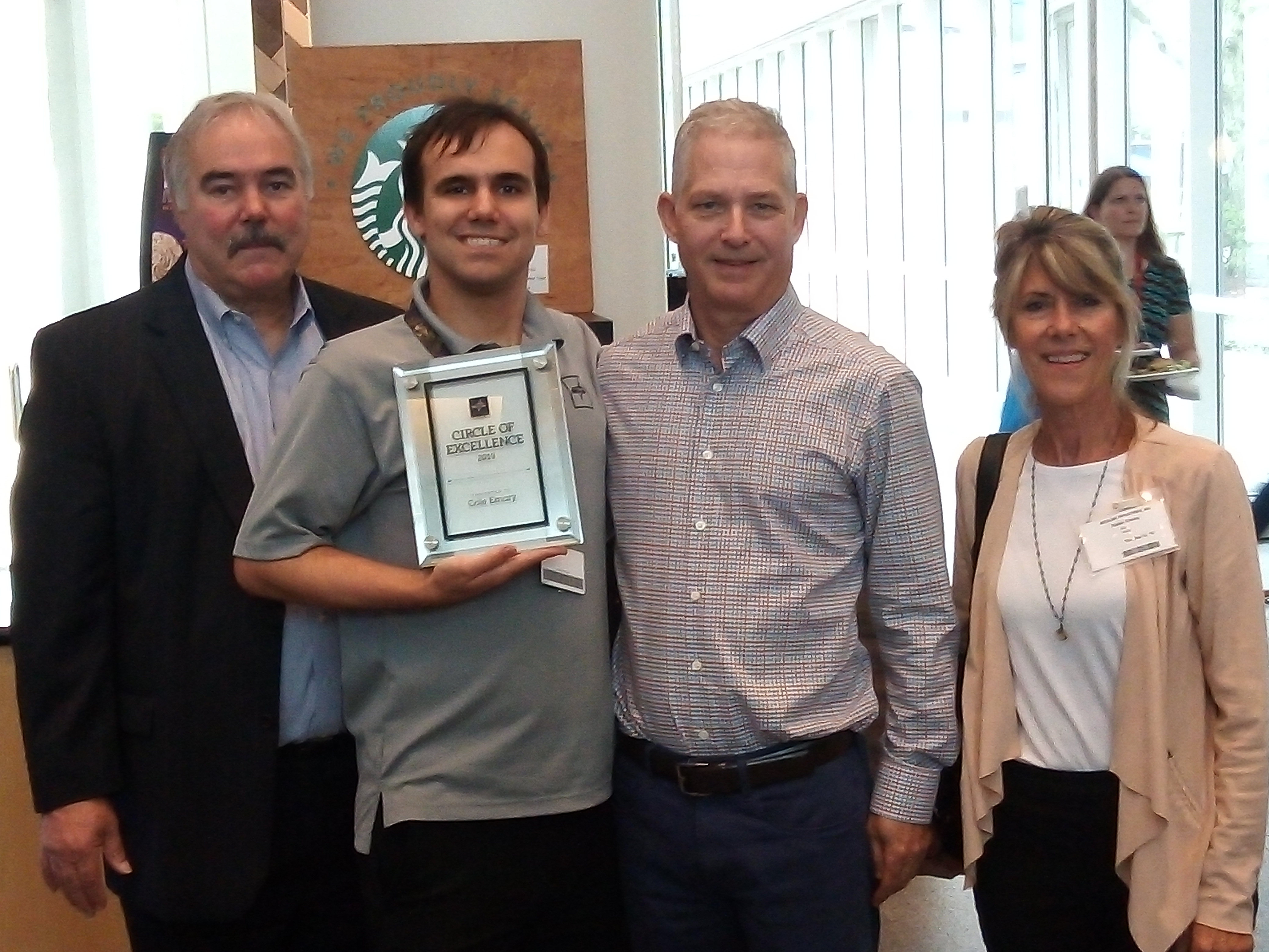 Cole with his parents and supervisor