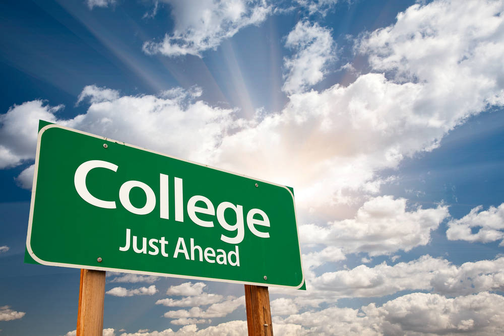 Roadside sign with "College Ahead" on it