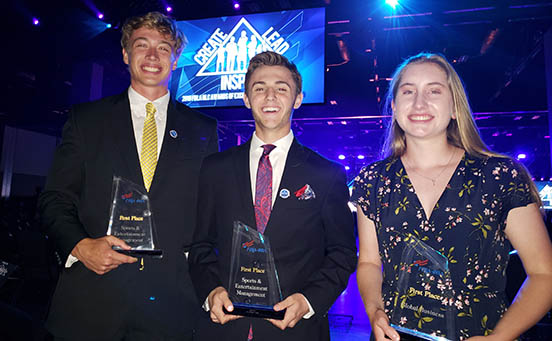 Three of the four honorees pose with their trophies