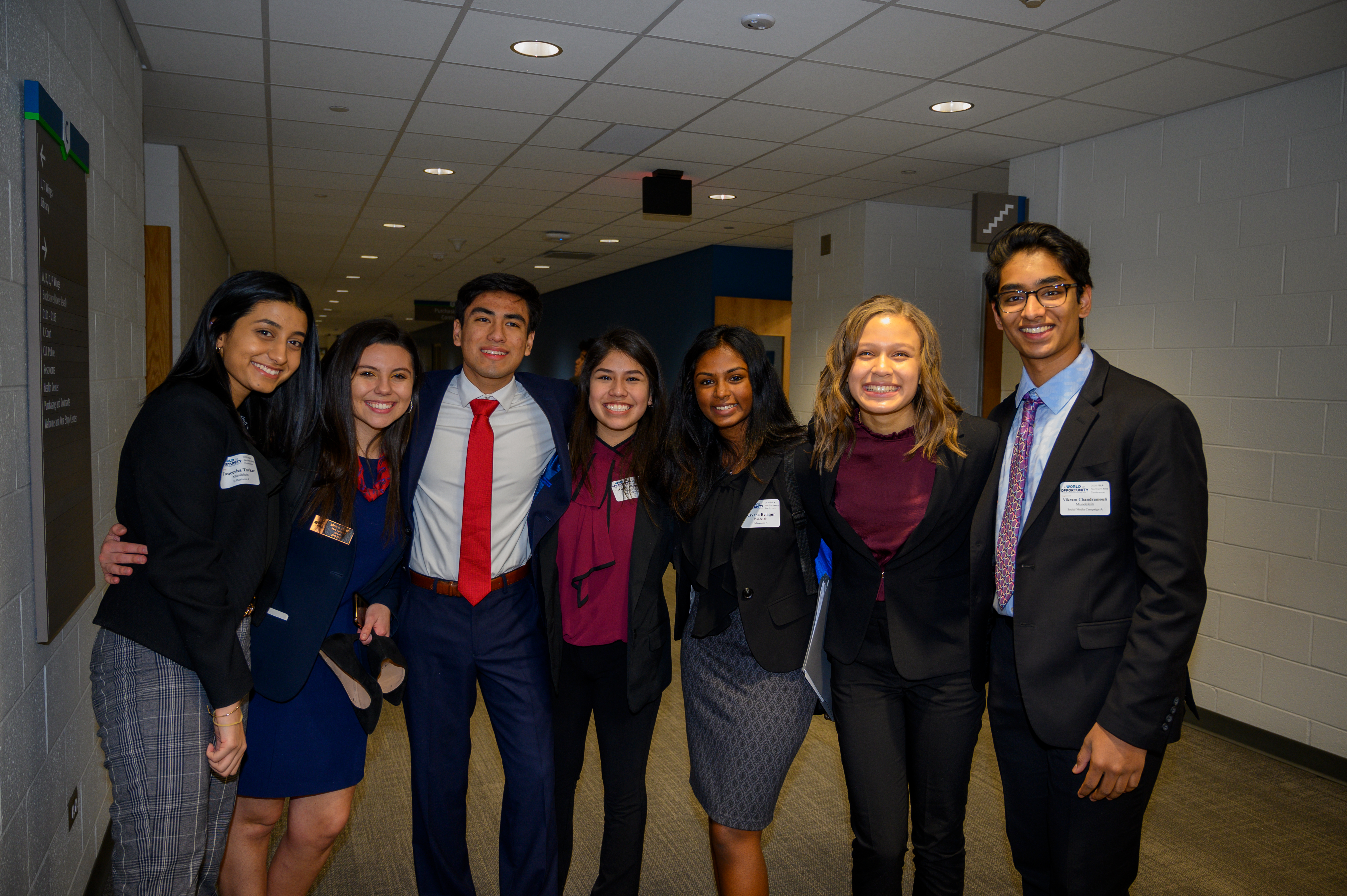 Seven of the award winners in group shot with arms around each other
