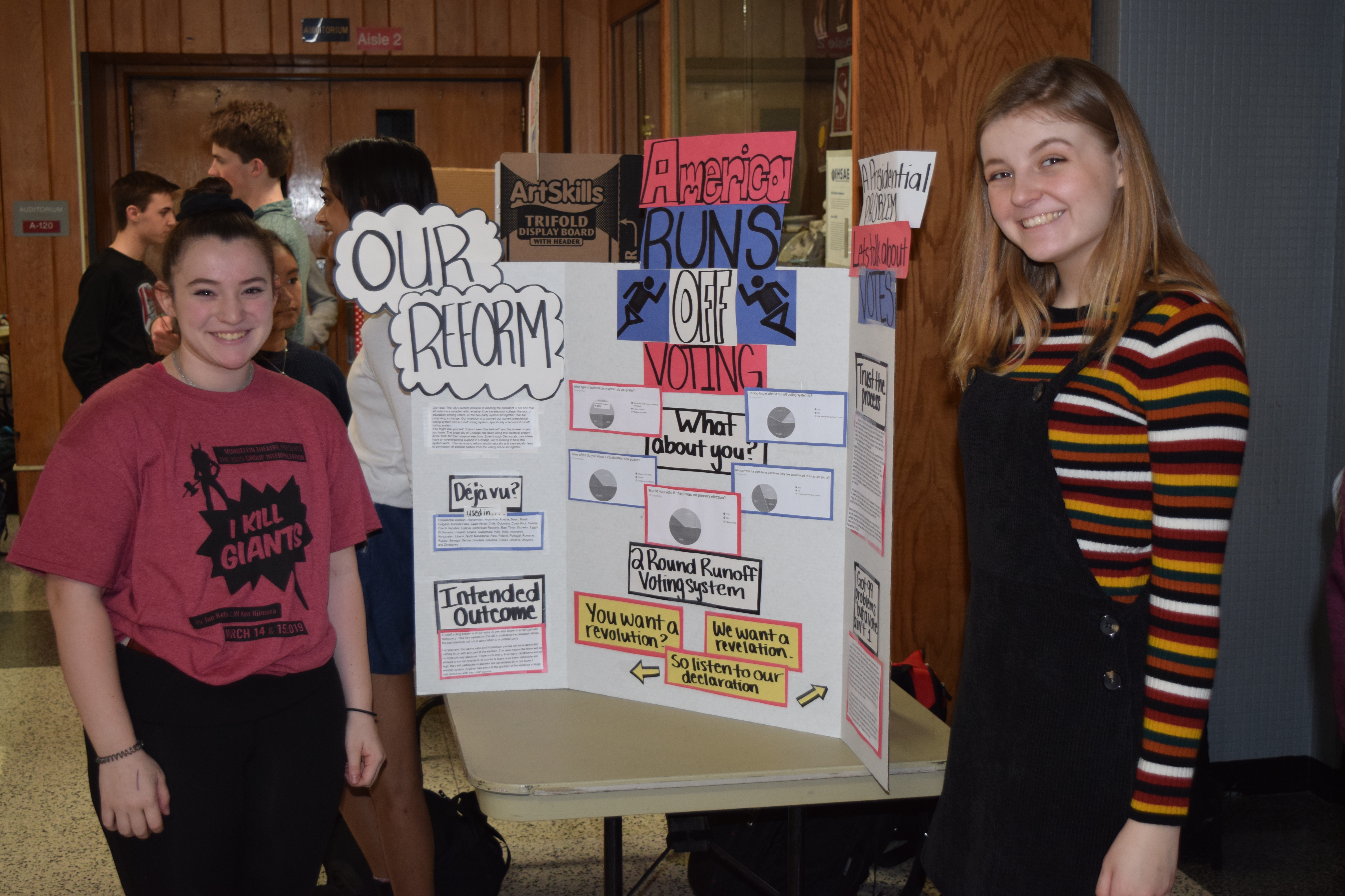 Students standing in front of their display