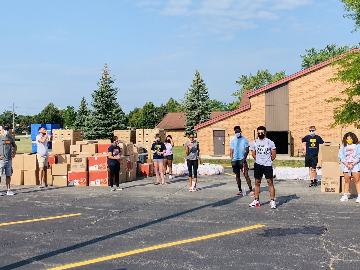 Student groups loading boxes of food for distribution