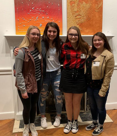 Four members of the team pose for a photo