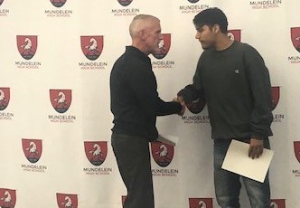Building and Grounds Director Kevin Quinn shakes hands with his nominee, Luca Lopez