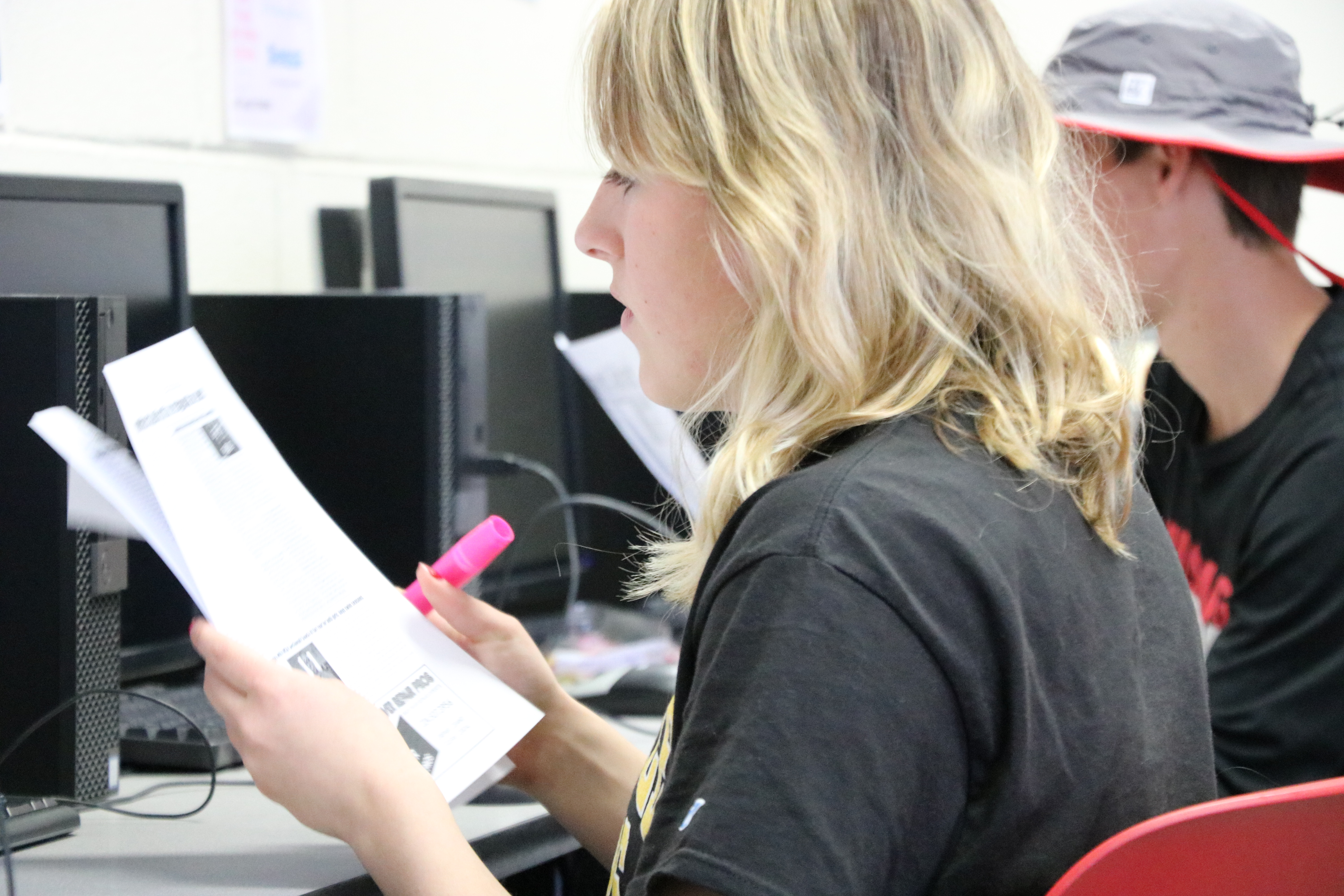 :  Proofreading a printed version of the March-April issue in the journalism room, Co-editors-in-chief Madison Parola and Tyler Yakimisky, both seniors, work together with the other editors to finalize the last regular issue of the year before sending it to the printer.
