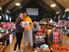 Two student volunteers hugging each other in front of all the food being provided