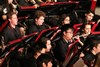 Close-Up shot of some band members playing their instruments at a concert