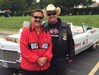 Frank standing in front of a convertible with a Distinguished Alumni  before the Homecoming Parade