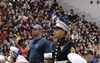 Two US Marines standing with the hundreds of attendees in the background
