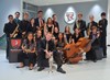 Group photo of Jazz Ensemble members sitting staggered on staircase