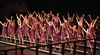The all-female group performs in sequined dresses