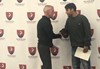 Building and Grounds Director Kevin Quinn shakes hands with his nominee, Luca Lopez