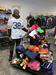 Chicago Bear, with jersey, helping to arrange clothing in the Welcome Center