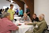 Retirees at breakfast being interviewed by student journalists