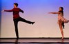 Male and female dance performing a dance on stage