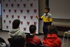 Alum speaking with students in the district meeting room