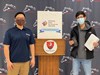 Razvi holding his award with Manny Aldana, PLTW instructor