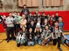 Members of the Robotics Team pose with their robots.