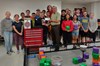 Markus shares a photo moment with members of the Robotics Team