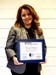 Victoria holding the plaque she received