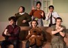 Six members of the cast posing with stuffed animals