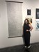 Becca Panos in front of her artwork