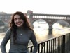 Photo of Carmen standing near historic landmark in Italy