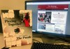 The printed version of the MHS yearbook stands next to a computer showing the school's digital newspaper.