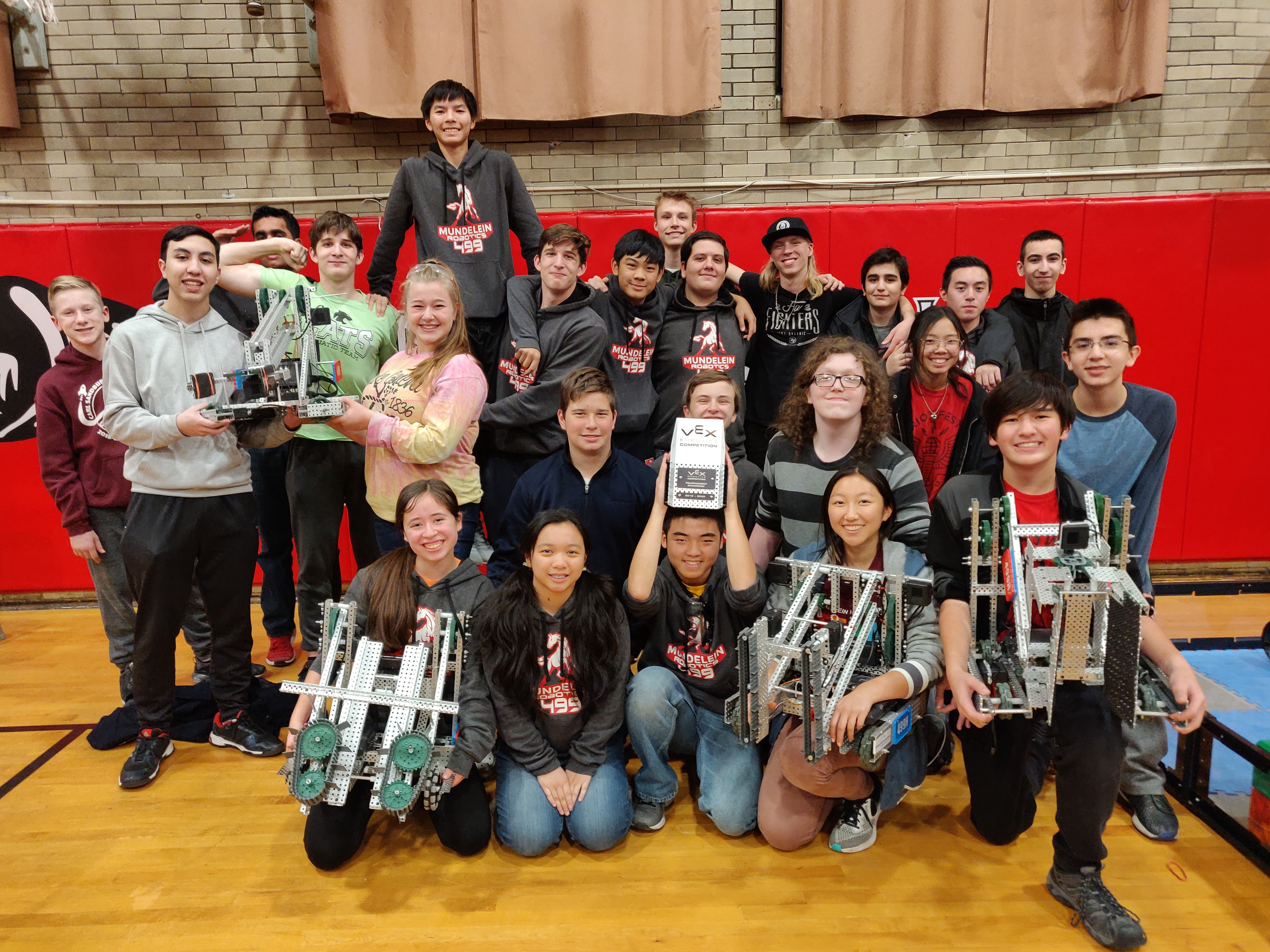 Members of the Robotics Team pose with their robots.