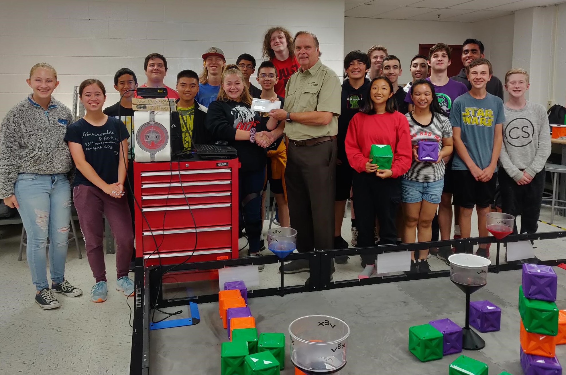 Markus shares a photo moment with members of the Robotics Team