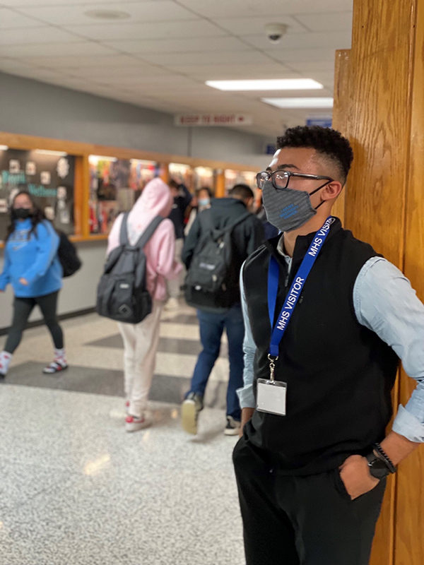 Trey Baker stands in the hall of Mundelein High School.