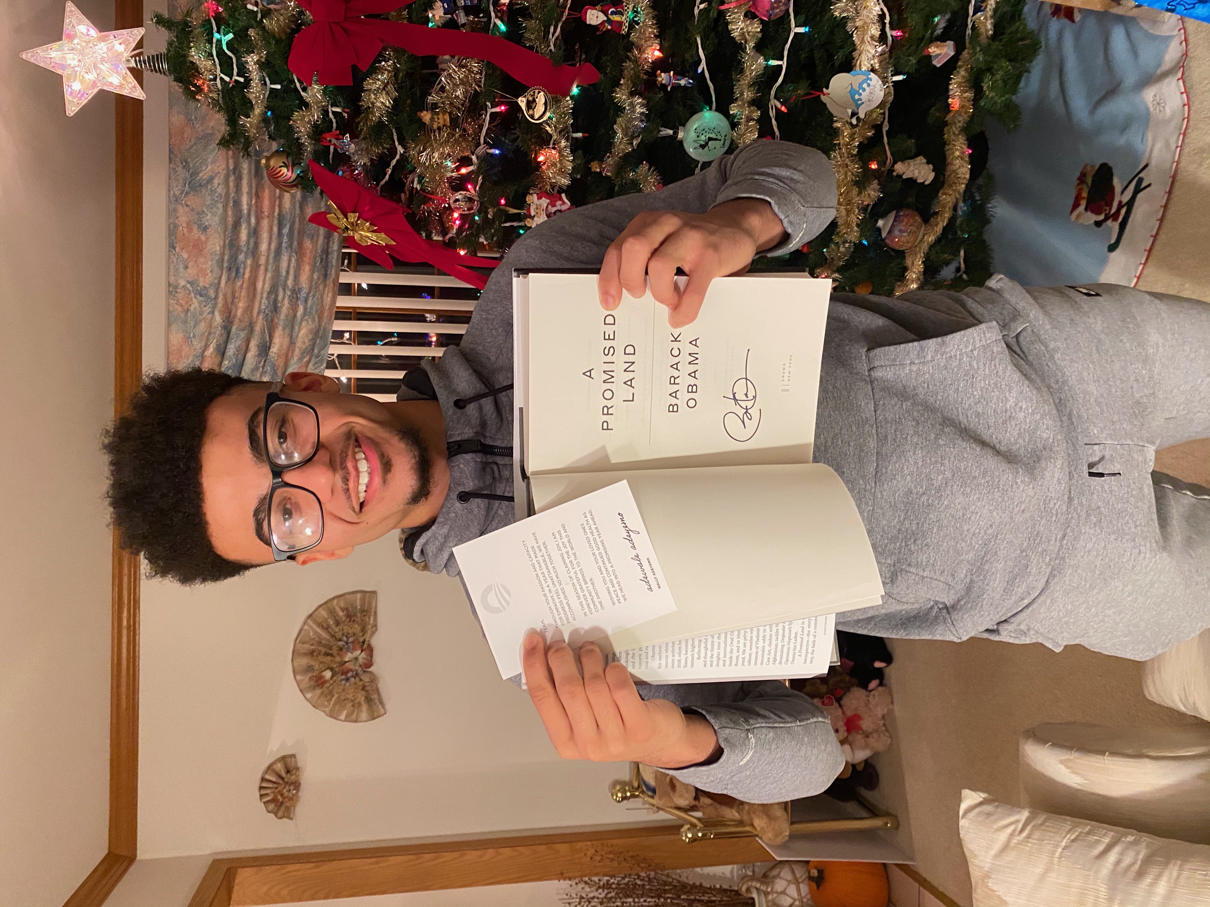 Trey holding up the signed book from President Obama
