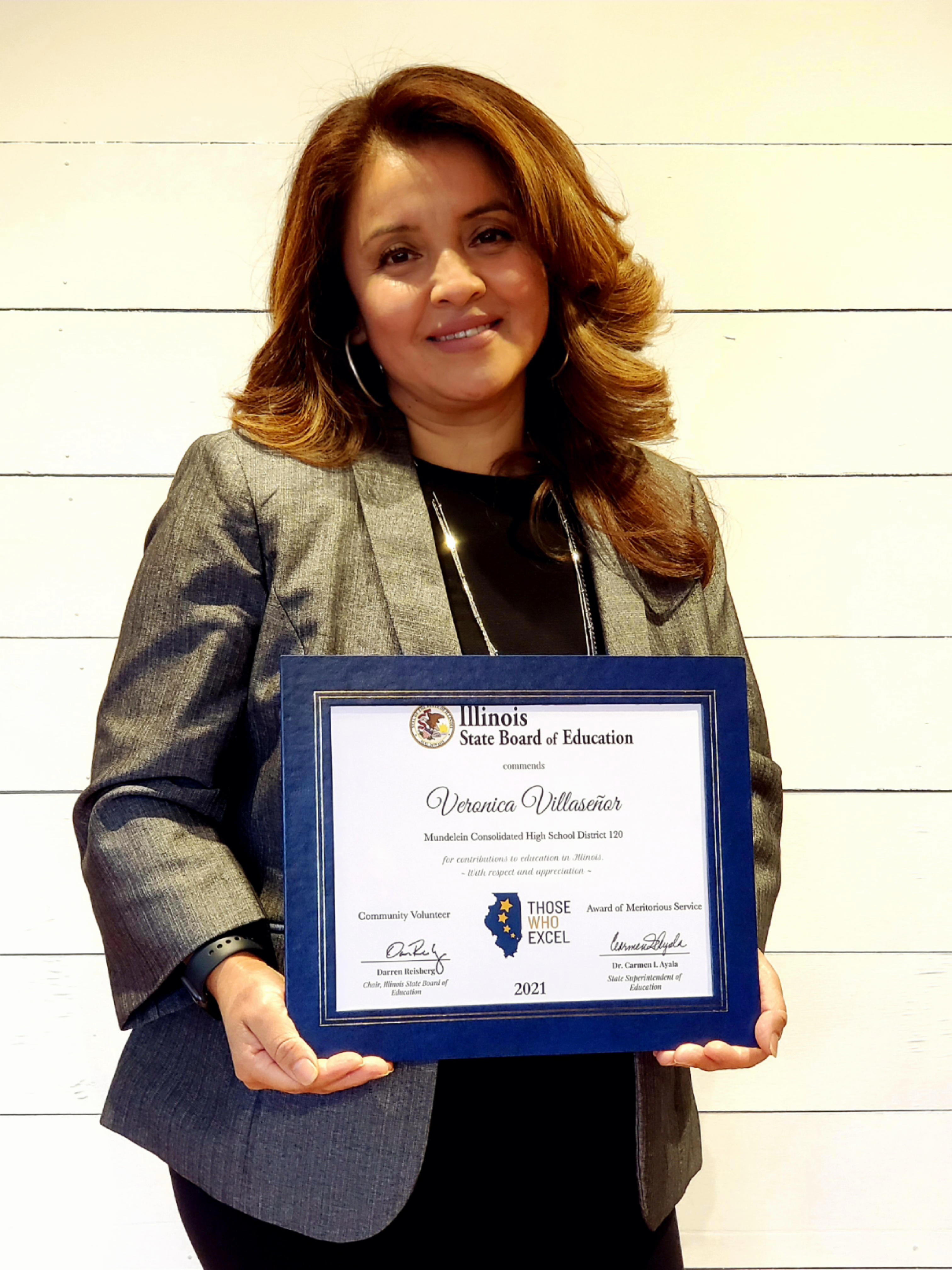 Victoria holding the plaque she received