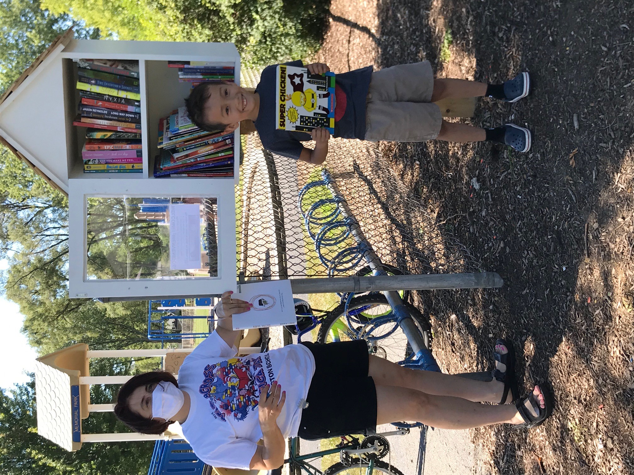 An adult and school child showing their books