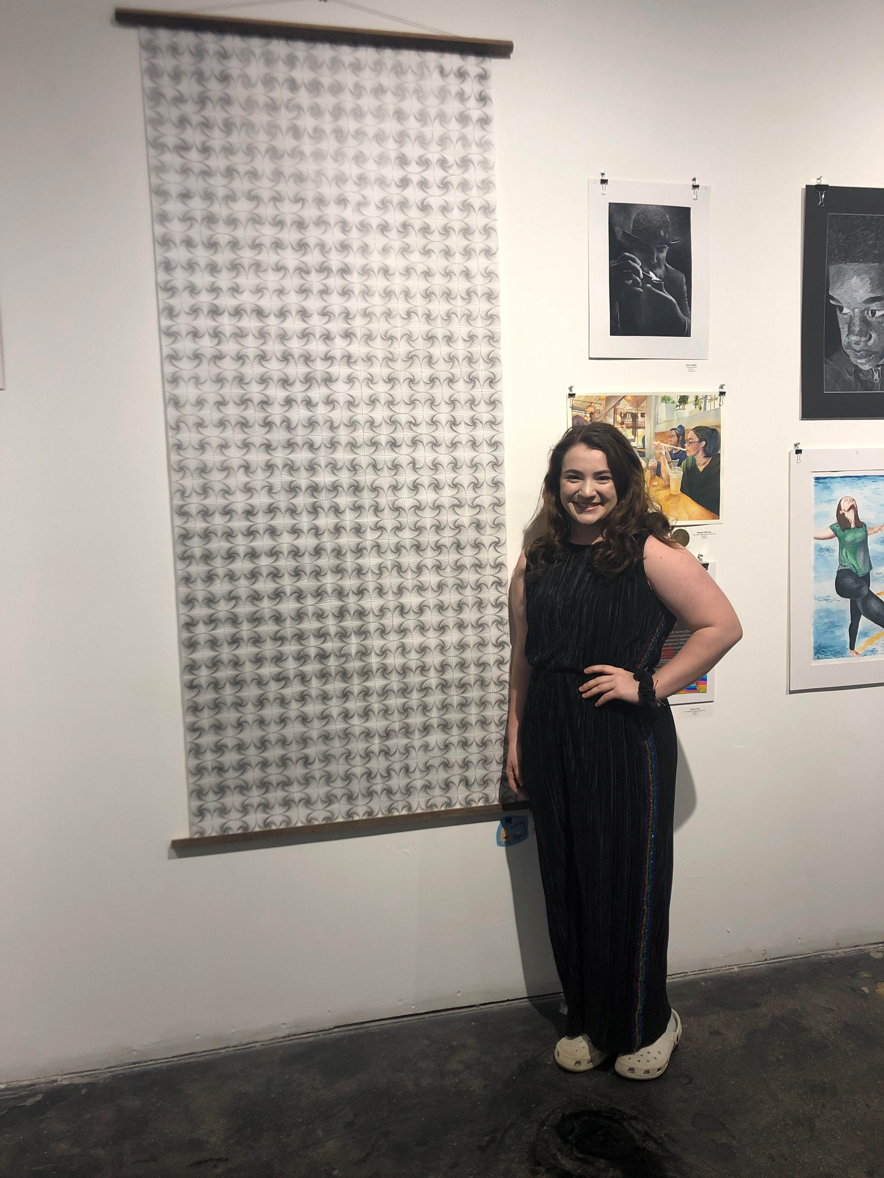 Becca Panos in front of her artwork