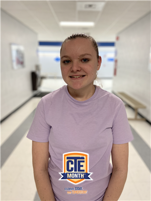 Photo of Natalia in the hallway of the Tech Campus wearing a CTE t-shirt
